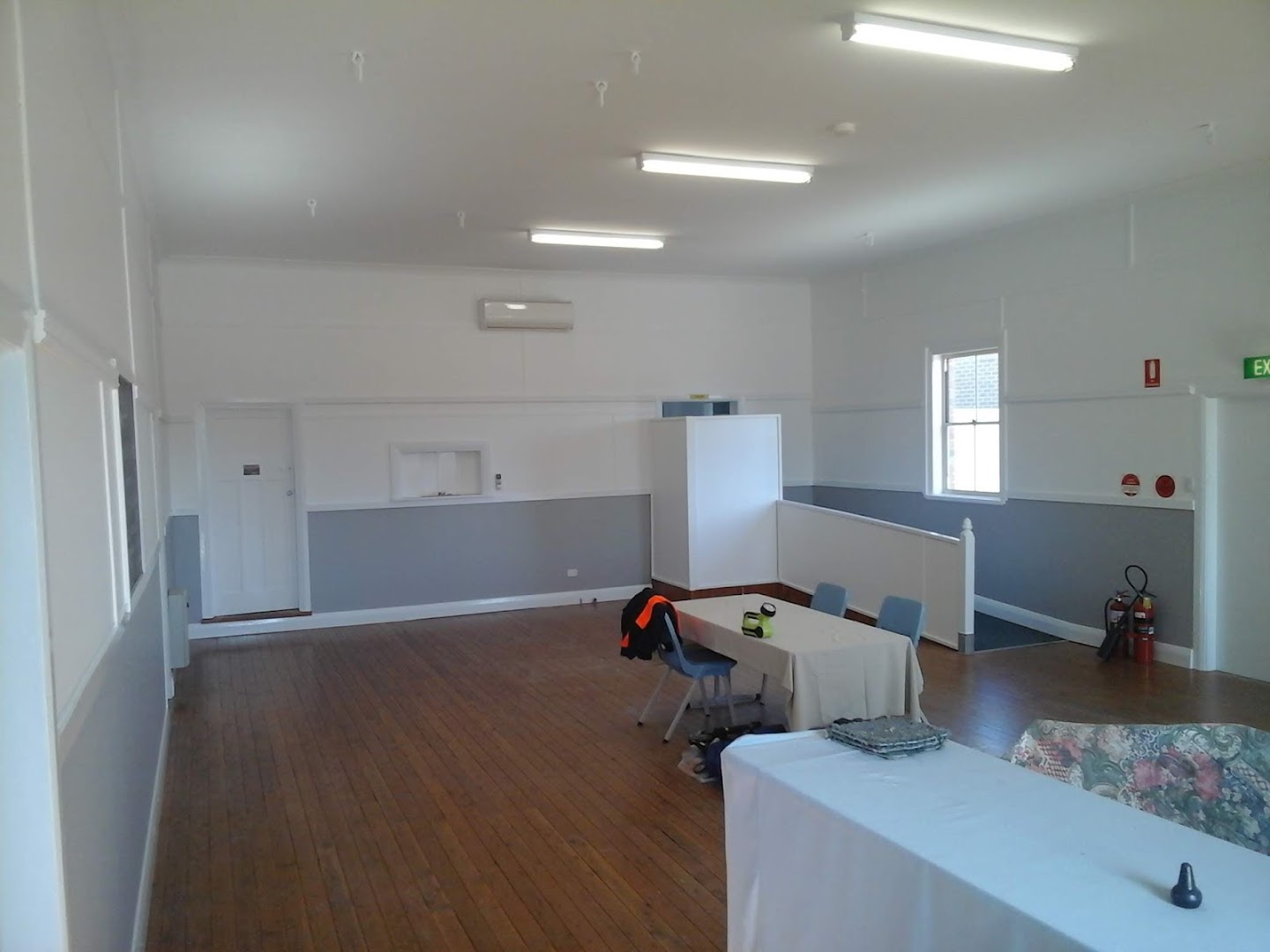 An empty commercial room with a benchtop and wide windows