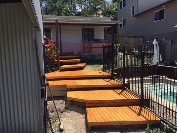Timber deck steps built beside a backyard pool