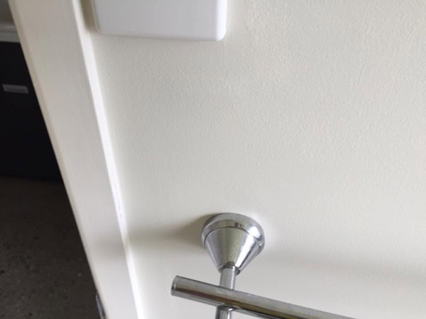 A chrome towel rail mounted on a bathroom wall