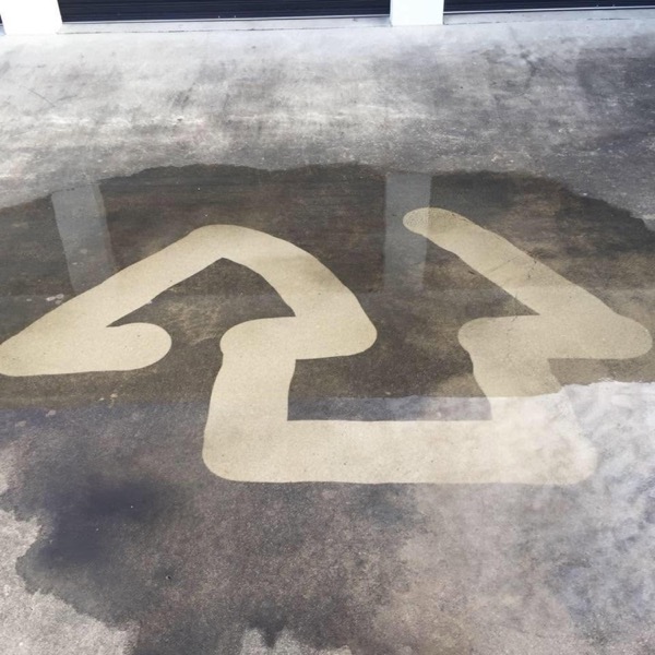 The Skywalker arrow mark pressure washed into a concrete driveway